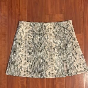 Olivaceous mini snakeskin skirt with slit on the side